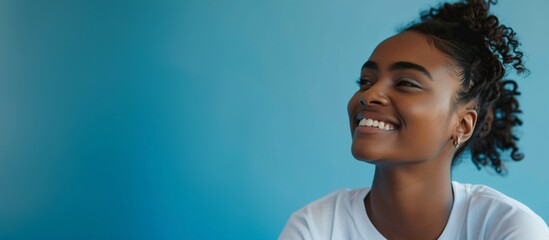 beautiful smiling black girl on isolated blue background