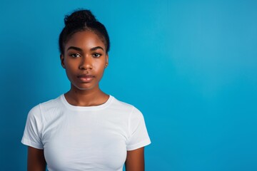 serious young attractive black girl on isolated blue backgroun