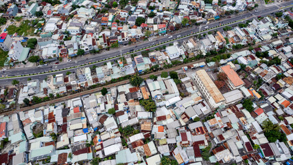 Aerial view of a dense urban area with closely packed houses and varied roofing, suitable as a background for themes on urban development and housing