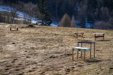 Temporary tables for picnic and bbq in mountains. Wierchomla, Beskid Sadecki in early spring.