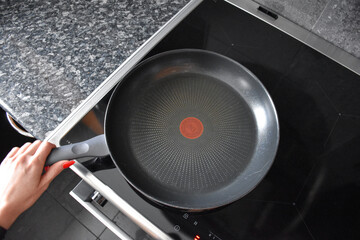 Teflon pans on the induction hob in the kitchen