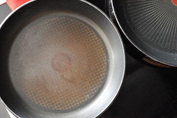 Teflon pans on the induction hob in the kitchen