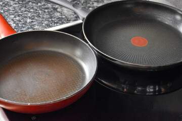 Teflon pans on the induction hob in the kitchen