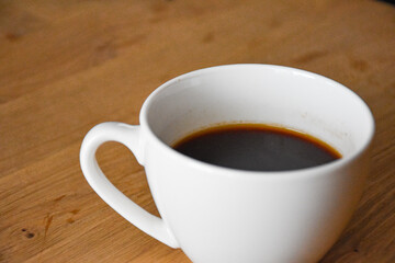 ceramic cup of hot coffee on the table