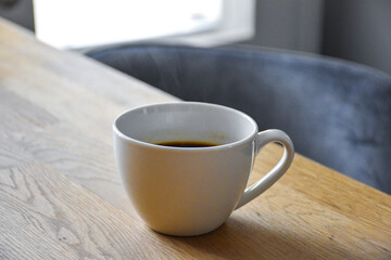 ceramic cup of hot coffee on the table