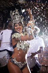 Carnival, woman and dancing in street with confetti and performance in Brazil, costume and feather...