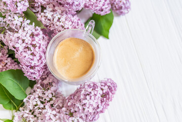 freshly brewed cup of coffee among vibrant lilac blossoms, capturing essence of tranquil spring morning