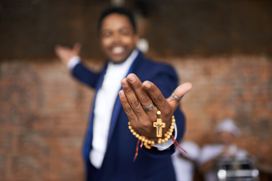Black man, christianity and hands with cross at church for holy welcome, faith or hope of spiritual leader. Closeup of African male person, priest or preacher with rosary beads for worship of god