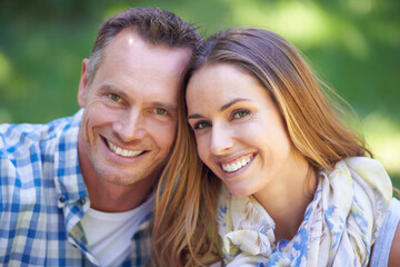 Fototapeta premium Portrait, bonding and couple with smile in park for summer romance, trees and fun outdoor date. Love, mature man and happy woman together in garden with morning sunshine, hug and marriage in nature.