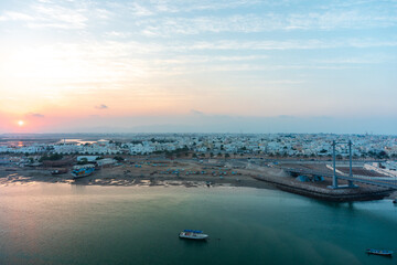 Sunset in Sur town. View on west part of the Sur city, Oman