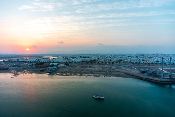 Sunset in Sur town. View on west part of the Sur city, Oman