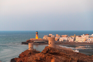 West part of Sur town with Al-Ayjah Lighthouse and Al-Ayjah Castle in golden hour time, Oman