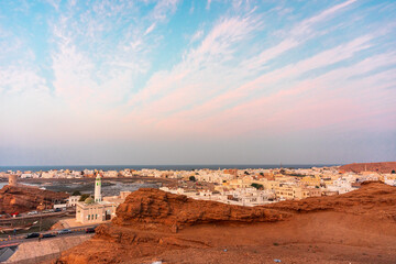 West part of Sur town with Al-Ayjah Castle, mosque in golden hour time, Oman.