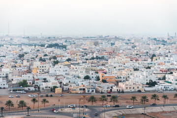 Residential buildings, city buildings, streets and roundabout in Sur, Oman