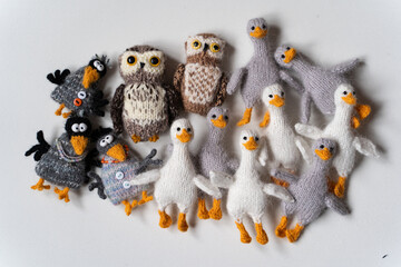 Knitted toys crows, geese, owls on a white background - 743657345