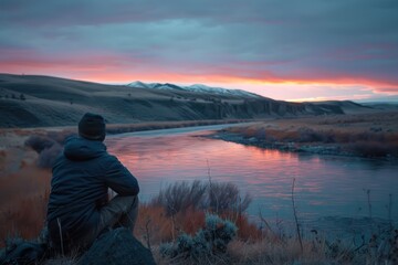 A lonely man looks into the distance. Beautiful forest landscape with lake
