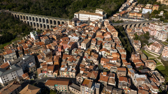 Aerial view of the bridge and the historic center of Ariccia, in the Metropolitan City of Rome, Italy. The houses of the town are built between the traditional alleys on the hill near Italian capital.
