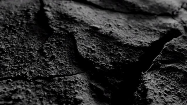 Rough rocky dark surface. Dark crumpled texture surface. Used as a background and texture.