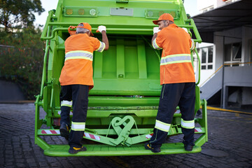 Worker, garbage truck and collection service on street or public environment with teamwork or junk,...