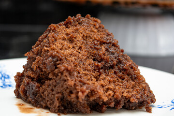 slice of chocolate cake over a marble dark background