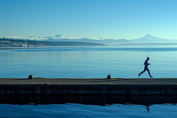 Person jogging along a peaceful waterfront