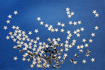 Abstract background with silver stars confetti glitter over blue background