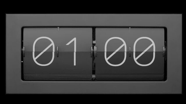 Flip clock quickly flips. Retro flip clock changing from 00:59 to 01:00. Slow motion.  