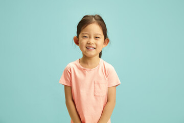 Cheerful portrait of elementary ages Asian girl radiates with a bright smile, expression joyful and...