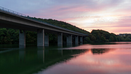 Bridge over the river in the evening. Beautiful sunset over the river.