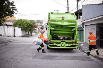 Garbage truck, junk and men with collection service on street in city for public environment...