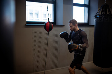 Concentrated boxer honing skills on double-end punching bag