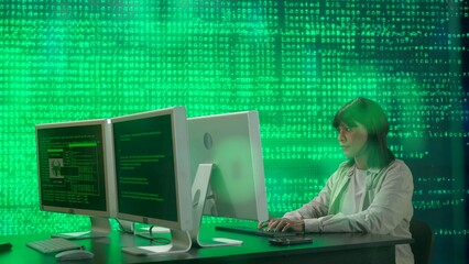 IT specialist against big digital screen. African american woman programmer works on computer in front of screen digital code data process.