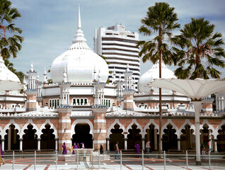 Kuala Lumpur, Malaysia - August 5, 2022: travelers touring the Masjid Jamek Mosque