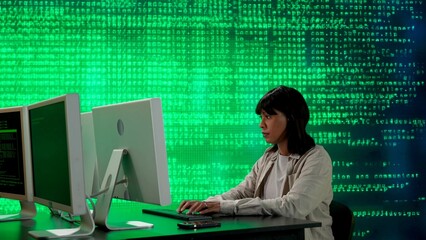 IT specialist against big digital screen. African american woman programmer works on computer in front of screen digital code data process.
