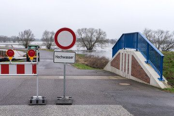 Flooding on the Elbe with dike protection system and warning sign