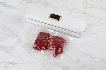 Vacuum packer machine. Vacuums the beef steak. Long-term storage of food products.