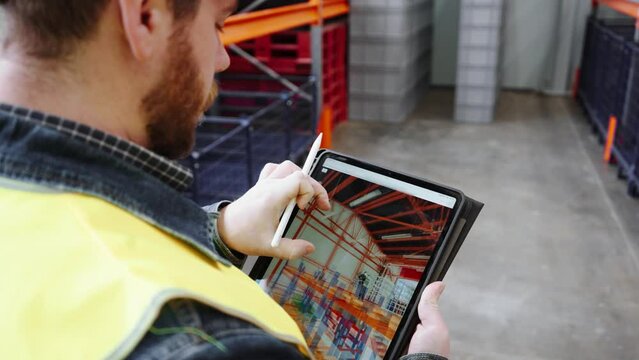 The quality manager engineer checks the constructed metalwork object for compliance with the 3D model in the tablet.