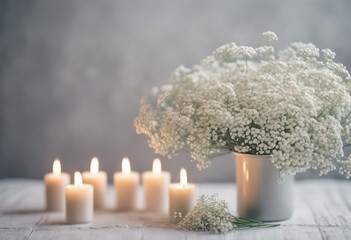 White arrangement of babys breath flowers and candles Copy space for lettering