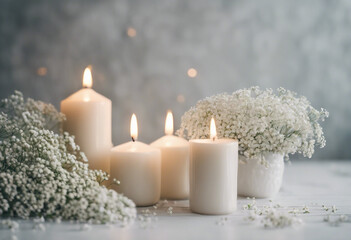 White arrangement of babys breath flowers and candles Copy space for lettering