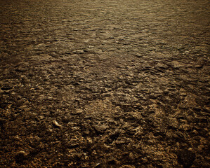 Worn out rough tarmac of a street. - 743715529