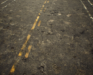 Worn out rough tarmac of an american highway. - 743715901