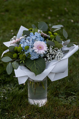 Birthday bouquet with beautiful flowers of pink Gerbera and blue Hydrangea. Beautiful flower in vase.