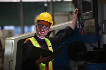 worker or engineer working in factory with safety uniform , safety hat and safety glasses , image is safety concept or happy workplace