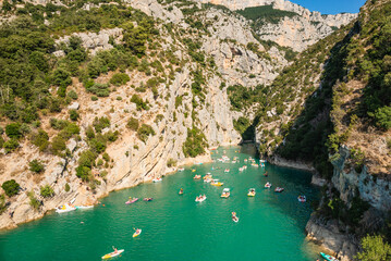The Verdon Gorge and lake of Sainte Croix du Verdon in the Verdon Natural Regional Park, France with kayaks and boats, canoe adventure sports activity.
