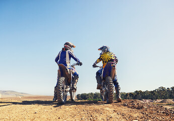 Rear view, sport or people on motorcycle outdoor on dirt road with relax after driving, challenge and competition. Sports, motorbike and dirtbike driver with helmet on offroad and path for racing