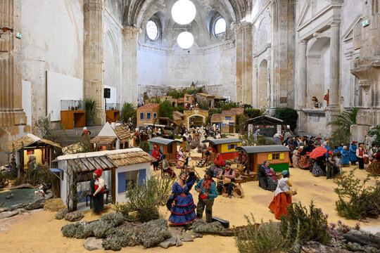 Arles, 12 29 2023 : Christ Child's crib, or nativity, in the tradition of the santon, or santons, of Provence. Arles, France. Chappelle des Trinitaires : Trinitaires Chapel in English.