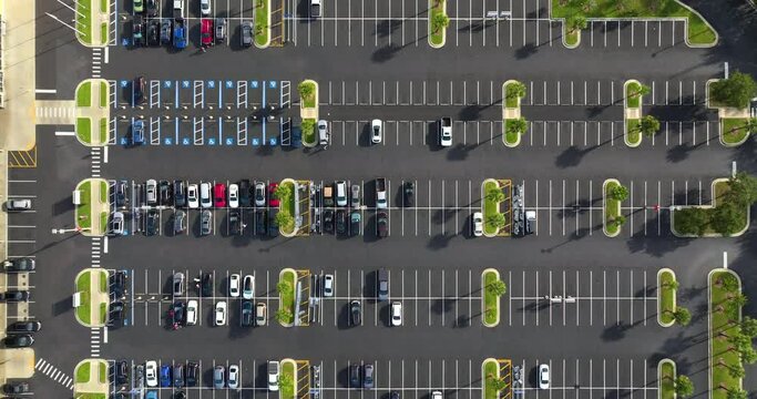Top view of many cars parked on a parking lot in front of a shopping mall in Tampa, Florida. Concept of urban transportation