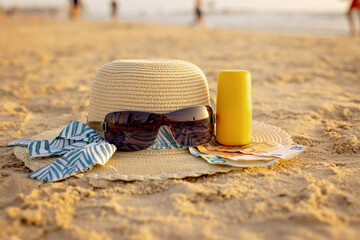 Vacation time - straw hat, sunglasses, suncream and money, ready for a holiday