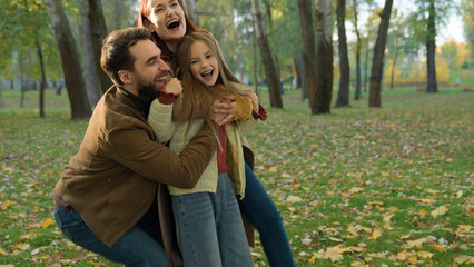 Happy family joyful laughing candid playing mom dad holding hands child kid daughter girl spinning...