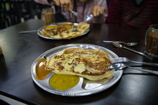 Traditional Malaysian roti canai meal on a table